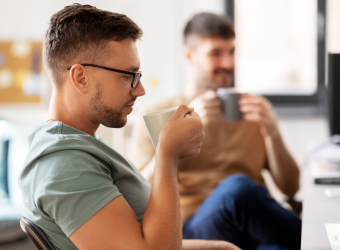 Men drinking a cup of coffee